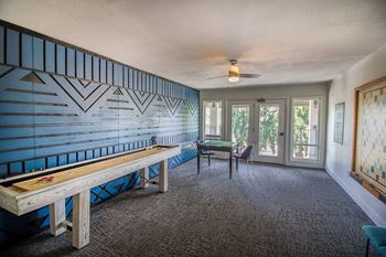 a living room with a bench and a table at Woodland Crossing , Woodland, CA